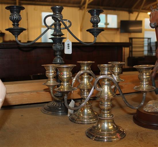 Pair of plated candelabra and a similar candelabrum(-)